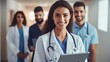© WS Studio 1985 - smiling doctor holds a computer tablet. Standing female healthcare professional holding test results with colleagues in the backdrop. generative ai
