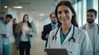 © WS Studio 1985 - smiling doctor holds a computer tablet. Standing female healthcare professional holding test results with colleagues in the backdrop. generative ai