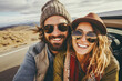 © MVProductions - Couple capturing a stylish selfie while embracing wanderlust on a road trip adventure
