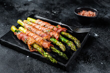 Asparagus Baked With Bacon And Spices. Black Background. Top View