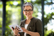 © Prostock-studio - Happy middle aged woman freelancer using digital tablet