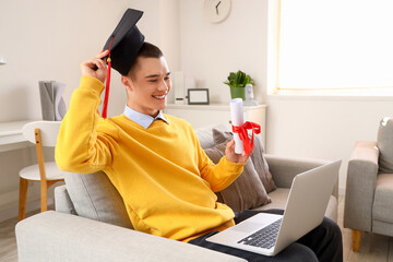 Poster - Male graduate student with diploma and laptop video chatting at home