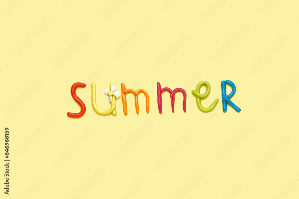 Word SUMMER made of play dough on yellow background