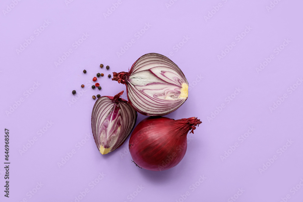Fresh red onions and peppercorn on lilac background
