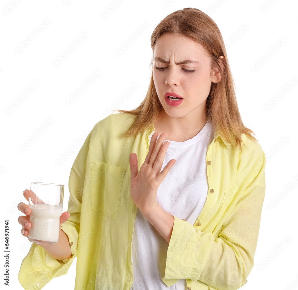 Young woman with lactose intolerance refusing to drink milk on white background