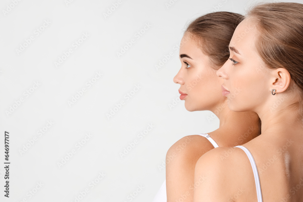 Portrait of attractive young women on light background