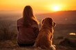 golden retriever puppy and its human companion enjoying a serene sunset together