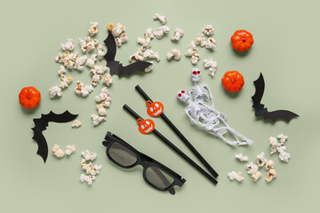 Sticker - Composition with tasty popcorn, straws, 3D glasses, paper bats and pumpkins for Halloween celebration on green background