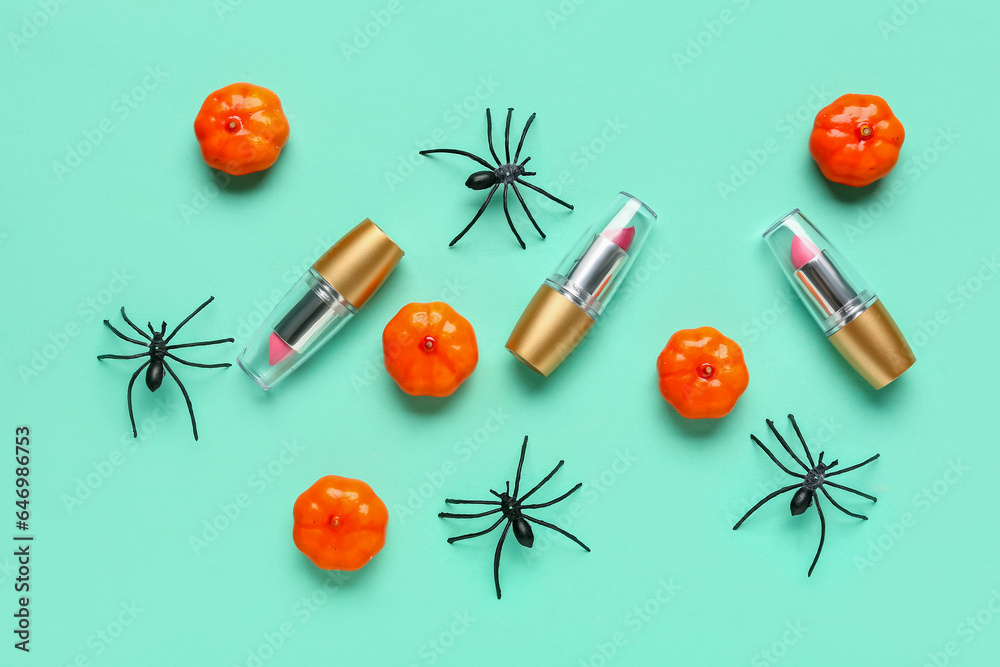 Lipsticks with Halloween decor on green background