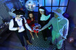 © Pixel-Shot - Group of friends in costumes drinking at Halloween party