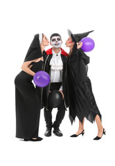 Sticker - Young friends in costumes for Halloween party with balloons on white background