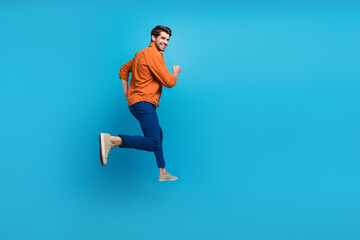 Aufkleber - Full length profile rear photo of overjoyed cheerful person jumping rush empty space isolated on blue color background
