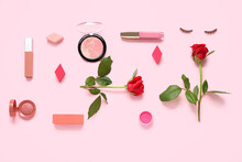 Composition With Makeup Products And Beautiful Red Rose Flowers On Pink Background