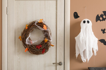 Door with wreath in hall decorated for Halloween