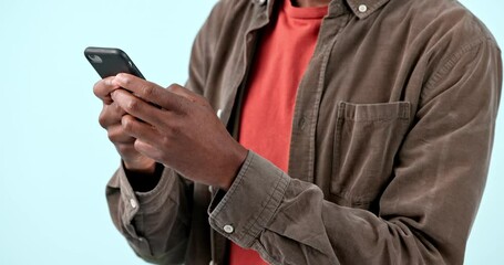 Poster - Hands, smartphone and man typing in studio isolated on blue background. Phone, closeup and person scroll on internet search app, social media networking and online communication on digital technology