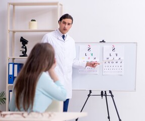 Wall Mural - Young woman visiting male doctor oculist