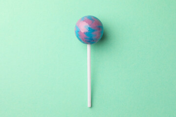 Wall Mural - Tasty lollipop on turquoise background, top view