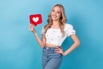 Sticker - Photo of nice girl young age wear crop top blouse holding paper red heart symbol subscribe blogger heart isolated on blue color background