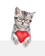 Sticker - Smart cat wearing eyeglasses holds red heart above empty white banner. isolated on white background