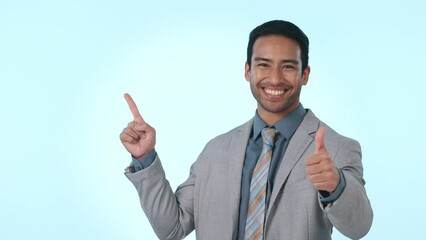 Poster - Thumbs up, pointing and business man on blue background for promotion, advertising and deal. Mockup, happy and portrait of worker with hand gesture for approval, agreement and showing in studio