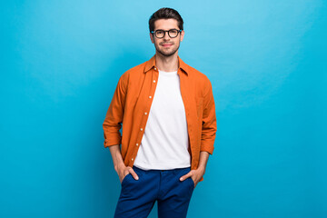 Fototapete - Photo of confident successful calm company lawyer man put arms pockets posing isolated on blue color background
