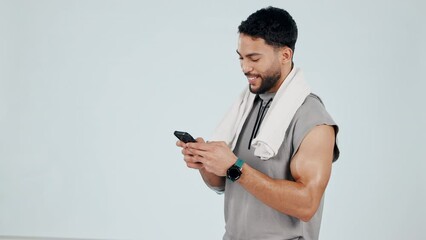 Canvas Print - Happy man, phone and typing in fitness, communication or social media against a studio background. Male person smile for online search, chatting or texting on mobile smartphone app on mockup space