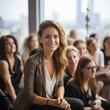 © Margo_Alexa - portrait of a young business woman with colleagues at a lecture or conference.