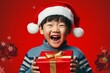 クリスマスプレゼントを貰って喜ぶ日本人の男の子（家族・ファミリー・育児・子育て・アジア人）