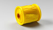 © hocine - A yellow plastic spool of thread for sewing sits on a white background. The spool is cylindrical with a hole in the center and the thread is wound tightly around it.