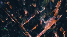Aerial View Of Glowing City Streets In Night Time. Hong Kong City From A Drone.
