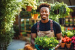 Young black male landscaper doing his job. Young man gardener working in greenhouse.