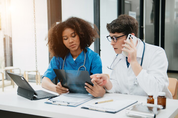 Two scientist or medical technician working, having a medical discuss meeting with an Asian senior female scientist supervisor in the laboratory with online reading, test samples