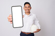 © Bangun Stock Photo - Professional engineer young Asian men wearing formal shirts and protective construction helmet holding big smartphone with blank screen while smiling expressions isolated on white background