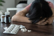 © Shisu_ka - asian woman use pills overdose, stressed, sad, drug abuser, drug addict, sick, unhealthy, unhappy, suicide, depressed or hopeless, Anti drug, drug addict, life and family problems, unmotivated