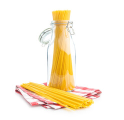 Wall Mural - Spaghetti pasta in glass bottle. Uncooked italian pasta isolated on white background.