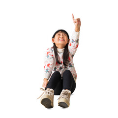 Portrait of attractive cheerful Asian little girl Hands pointing looking up sitting on floor festal Christmas day December winter, full body, isolated on white and transparent background