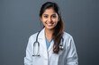 Young indian female doctor standing on white background.