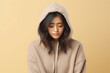 © Anastasiia - Sadness Asian Girl In Beige Hoodie On Pastel Background