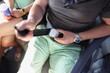 Close-up of man passenger fasten seat belt while sitting on airplane during vacation trip. Safety travel, protection, security, flight, departure concept