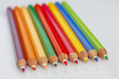 colorful wooden crayons on a light background