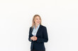 © Vitaliy - Attractive blond businesswoman standing and smiling isolated on white background