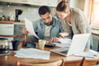 © Geber86 - Worried young Caucasian couple going over their bills and home finances in the morning in the kitchen