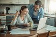 © Geber86 - Worried young Caucasian couple going over their bills and home finances in the morning in the kitchen