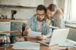 © Geber86 - Worried young Caucasian couple going over their bills and home finances in the morning in the kitchen