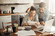 © Geber86 - Worried young Caucasian couple going over their bills and home finances in the morning in the kitchen