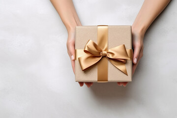 Sticker - Overhead view of a woman holding a christmas present with ribbon bow