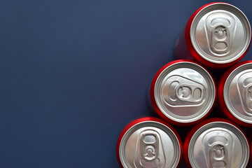 close up top of aluminium red cans soft drink put on blue texture background