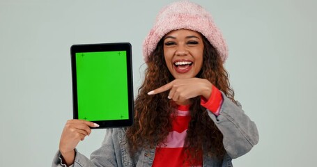 Poster - green screen, tablet and woman pointing for review of mobile app with hand gesture isolated in studi