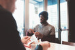 © Eugenio Marongiu - african man sitting in coffee bar with friends