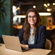 Young happy professional business woman employee sitting at desk working on laptop